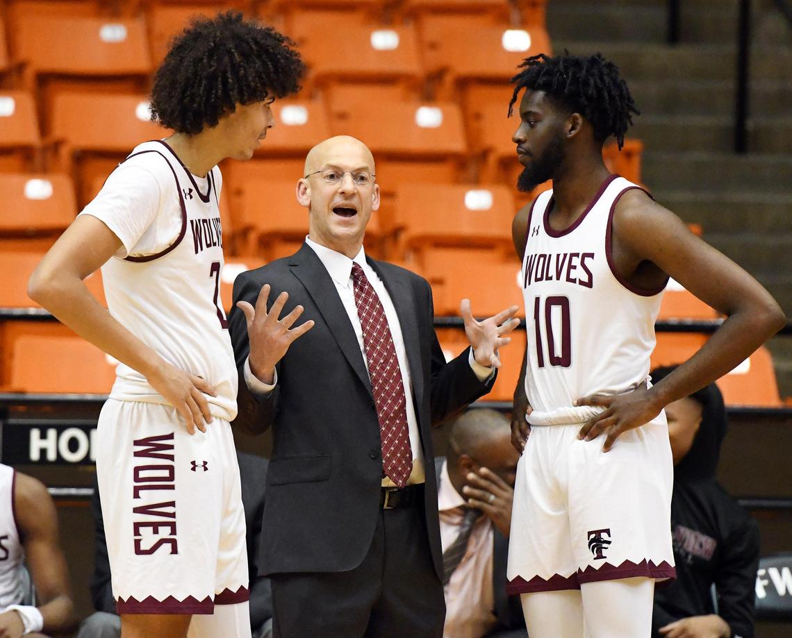 Timberview basketball coach Duane Gregory, center gives instructions to Cameron Taylor, left and Ahmad Richardson in the final seconds of their 59-45 winof their Bi District Playoff basket ball game against Eastern Hills, Monday, February 24, 2020 at Wilkerson Greines Activity Center in Fort Worth. Texas. Special/Bob Haynes