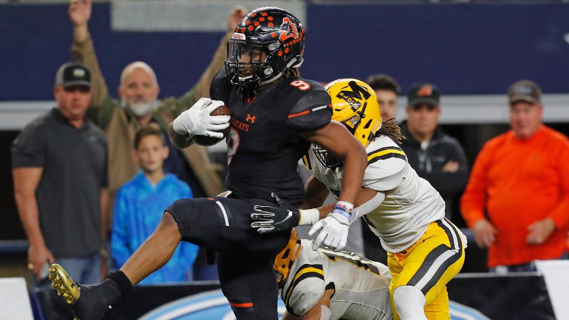 Aledo running back Jase McClellan (9) high steps into the end zone in front of Marshall defensive back Jaylon Wilson (7) in the first half of a Texas High School 5A Division II State Championship football game at AT&T Stadium, Arlington, Texas, Friday, Dec. 21, 2018. Aledo led 28-12 at the half. (Star-Telegram Bob Booth)