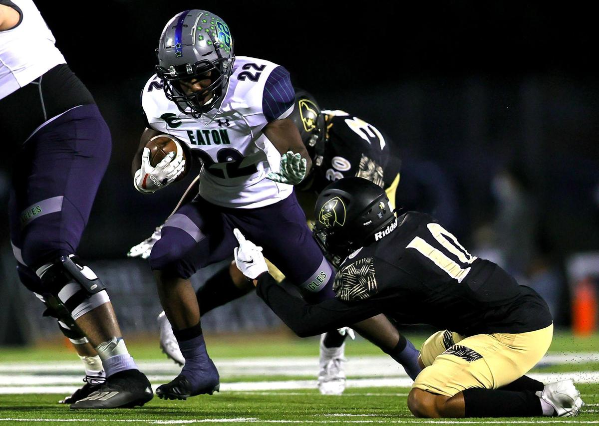 Eaton running back Jahbez Hawkins (22) tries to break free from Keller Fossil Ridge defensive back Kayvon Evans (10) during the first half of a high school football, October 22, 2020 played a Keller ISD Stadium in Keller, Tx. (Steve Nurenberg Special to the Star-Telegram)