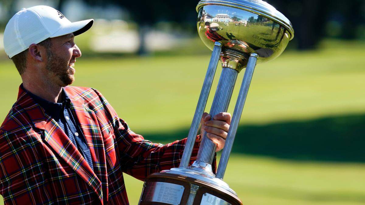 Daniel Berger poses with the championship trophy after winning the Charles Schwab Challenge golf tournament after a playoff round at the Colonial Country Club in Fort Worth last June. (AP Photo/David J. Phillip)