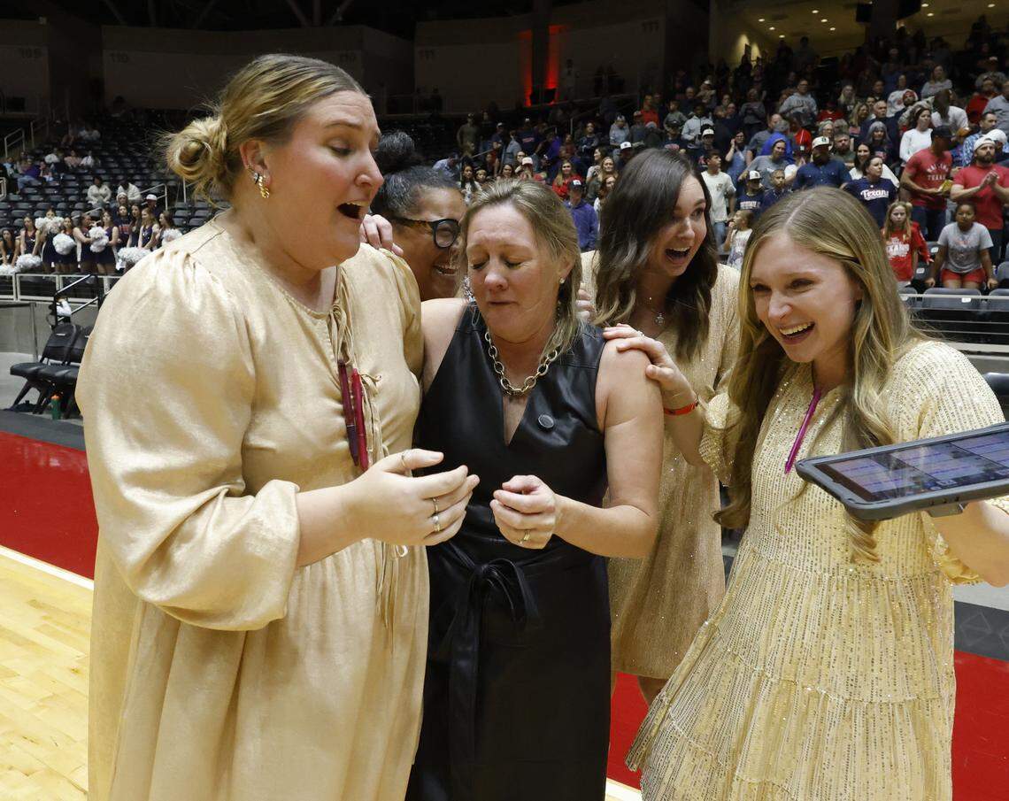 Fort Worth Eagle Mountain head coach Catherine Foerster, in black, gets emotional after winning the UIL Class 4A Division II state volleyball championship game against Wimberley Friday Nov. 21, 2025 at Curtis Culwell Center in Garland, Texas.