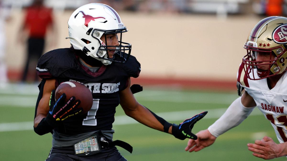 North Side wide receiver Lorenzo Perez (1) prepares to stiff arm Saginaw linebacker Tyler Self (11) in the first half of a UIL football game at Farrington Field in Fort Worth,Texas, Friday Sept. 01, 2023.