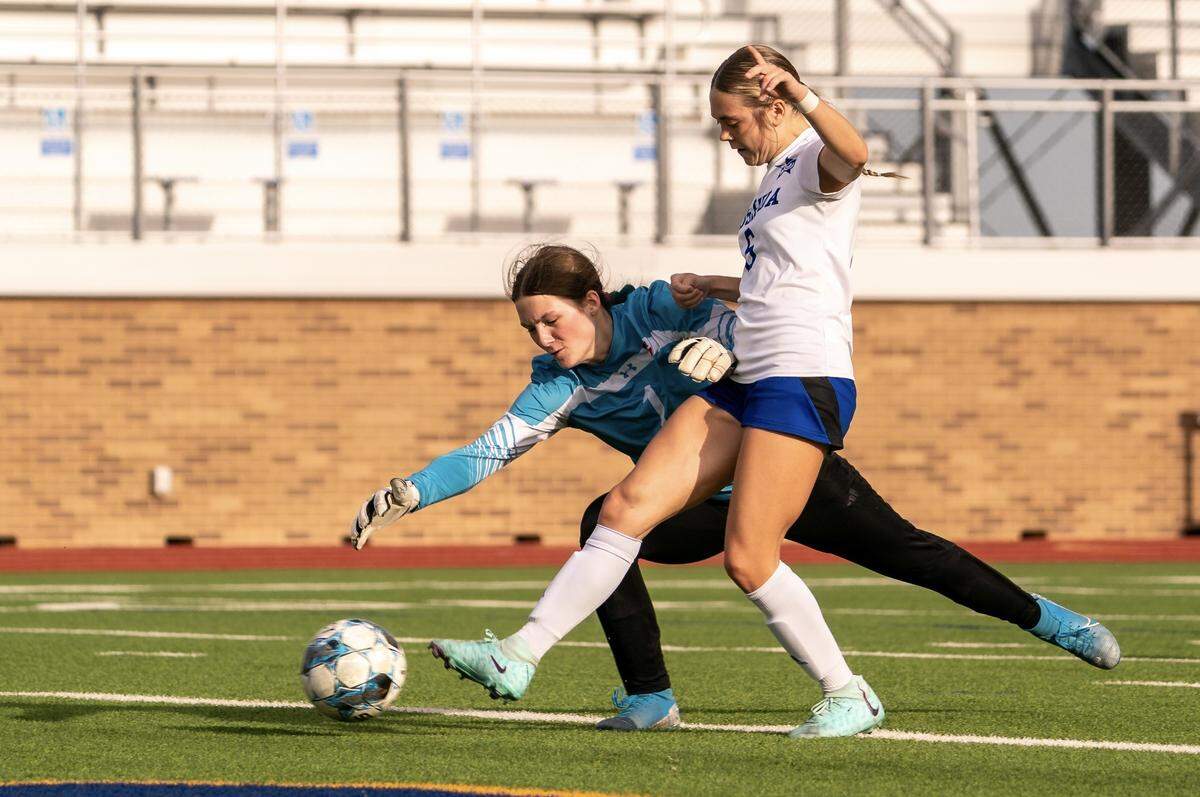 Joshua’ Hannah Day (6), right, scores after a misplayed ball by Justin Northwest goalkeeper Addison Roddam (1) in a Class 5A area-round girls soccer match on Friday, March 29, 2024 at Boswell High School in Fort Worth ,Texas. Joshua defeated Northwest 4-1.