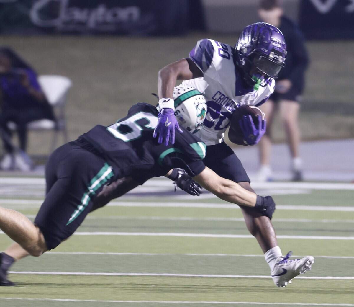 Southlake defensive back Parker Harris (6) brings down Crowley running back Kenyen Cotton (20) during the first half of a UIL Conference 6A D2 Bi-District playoff game between Crowley and Southlake Carroll at Dragon Stadium in Southlake, Texas, Thursday, Nov. 13, 2025.