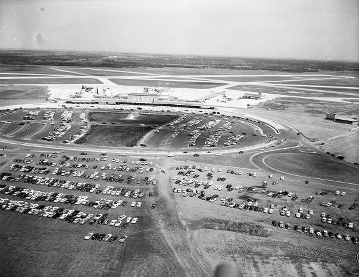April 16, 1953: An aerial view of the new Greater Fort Worth International Airport terminal, runway, parked airplanes, and parked visitor cars. The airport is also known as the Greater Southwest International Airport and Amon Carter Field.