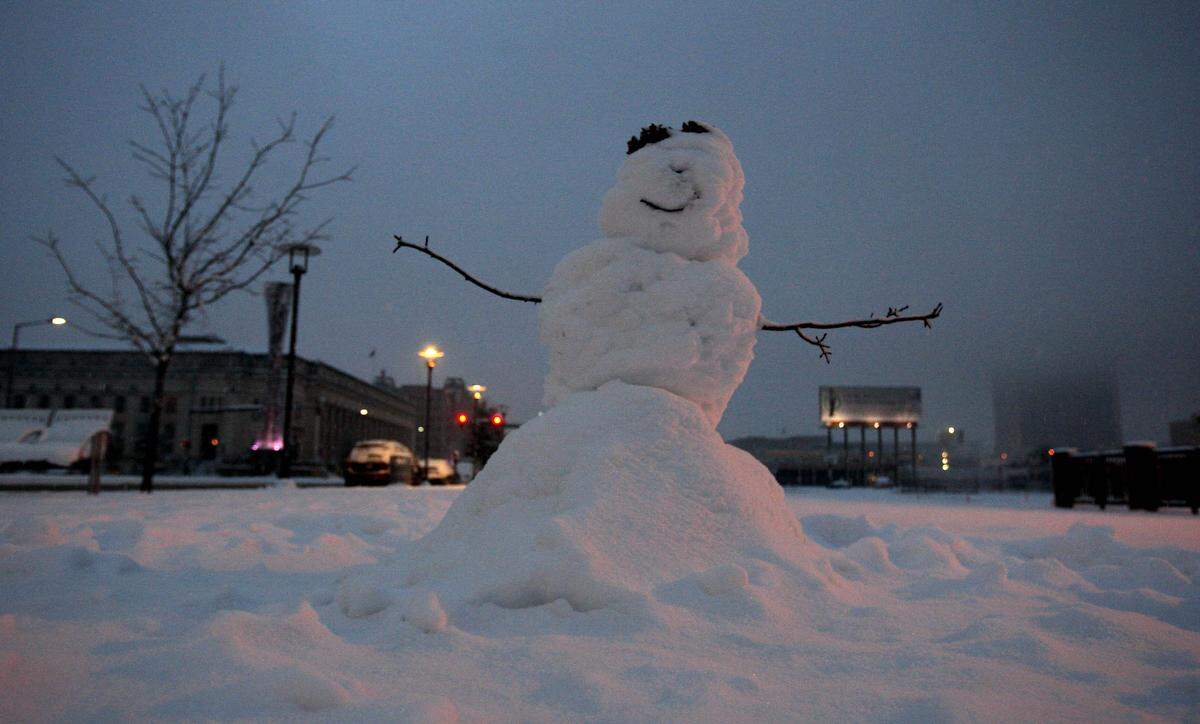 A snow man sits alongside Lancaster Avenue south of downtown as snow continues to fall, Thursday February 11, 2010.