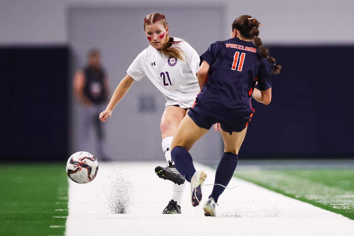 Grapevine defender Mollie Barborka (21) passes the ball as a Frisco Wakeland defender attempts to block the pass in a Class 5A Division II UIL girls soccer state semifinal at the Ford Center on April 3, 2026 in Frisco, Texas.