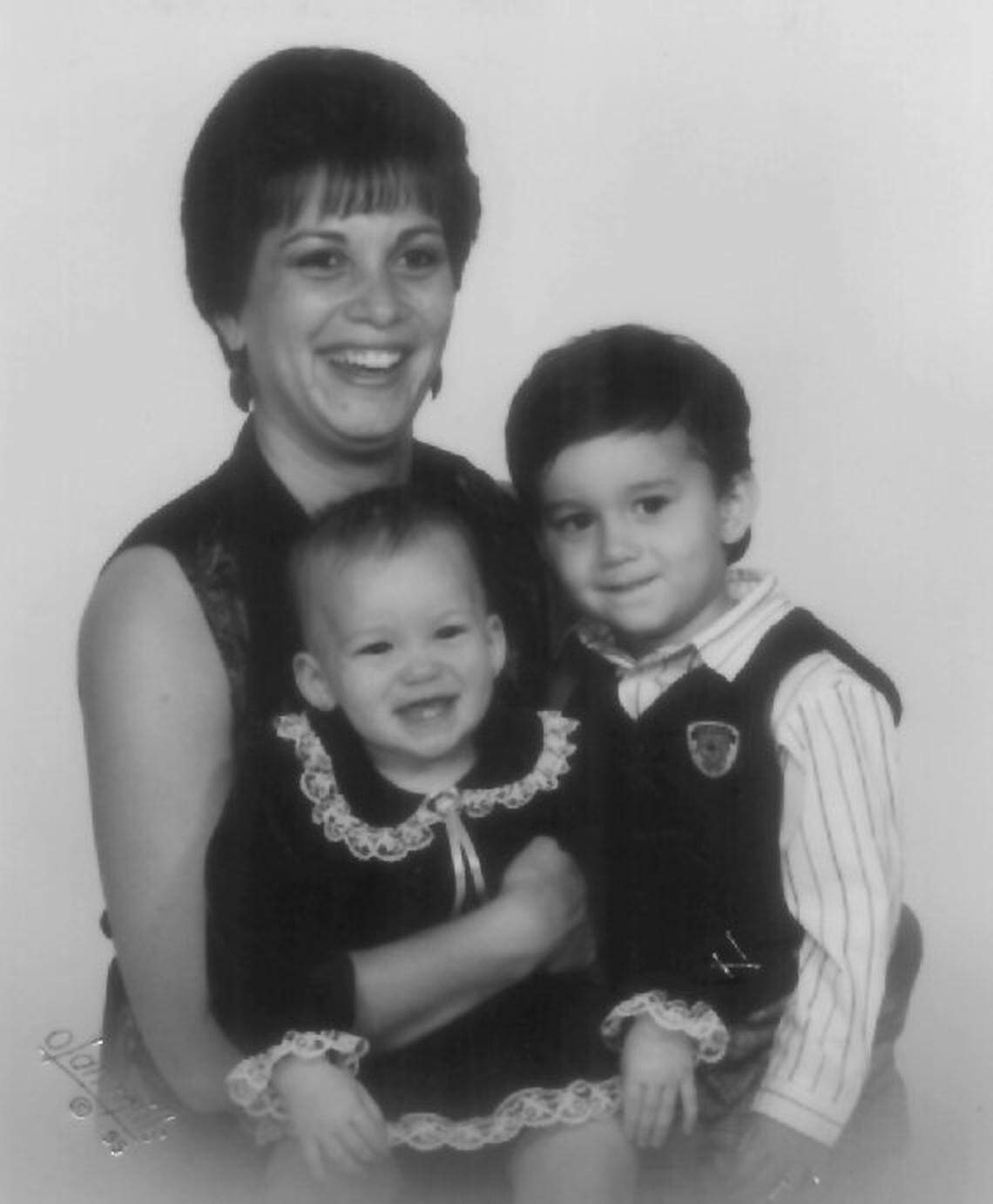 Sharon McLane, a mother of four, was found slain in her apartment in Bedford. She is pictured here with her two youngest children, 2-year-old Samantha and 4-year-old Dustin.