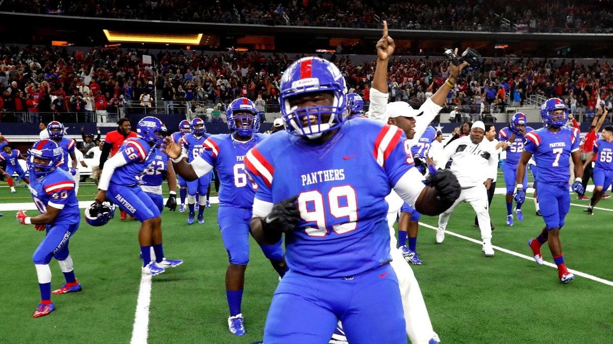 Duncanville defensive lineman Damijion Jackson (99) and the rest of the Panthers storm the field after their win of a high school Class 6A Division I State Semifinals football playoff game at AT&T Stadium, Arlington, Texas, Saturday, Dec. 15, 2018. Duncanville defeated Allen 44-35. (Star-Telegram Bob Booth)