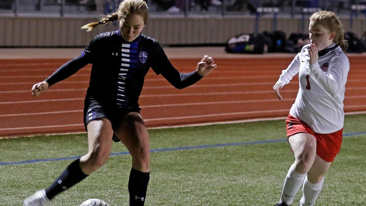 Centennial midfielder Journey Curs (16) kicks the ball in front of Burleson midfielder Olivia Nivens (1) during a 8-5A girls soccer game at Burleson Centennial in Burleson, Texas, Friday, Feb. 05, 2021. Centennial defeated Burleson 6-0. (Special to the Star-Telegram Bob Booth)