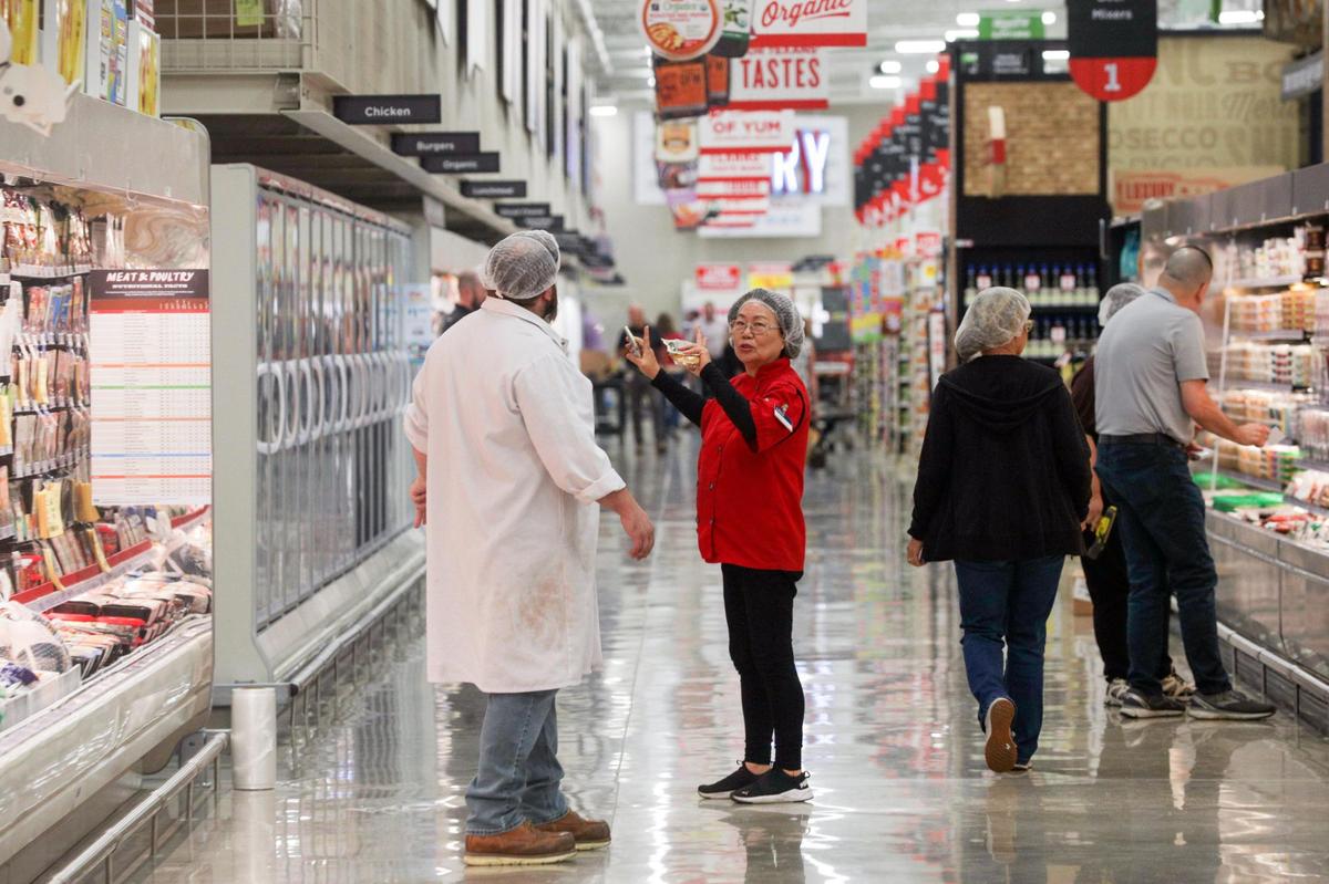 H-E-B employees prep the store the day before a new location opens in Frisco, Texas, on Tuesday, Sept. 20, 2022.