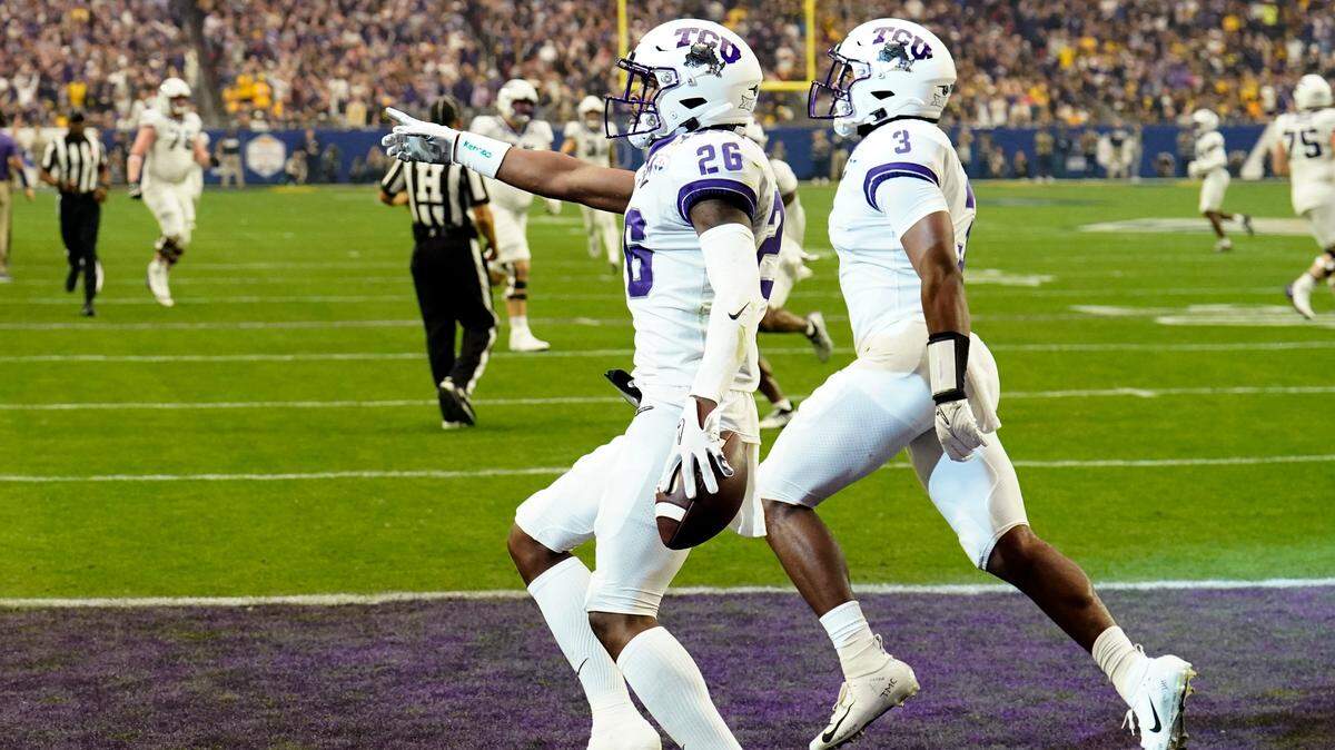 TCU safety Bud Clark (26) celebrate his interception for a touchdown against Michigan during the first half of the Fiesta Bowl NCAA college football semifinal playoff game, Saturday, Dec. 31, 2022, in Glendale, Ariz. Clark and the Horned Frogs learned the kickoff time for four games for the 2023 season Wednesday. (AP Photo/Ross D. Franklin)