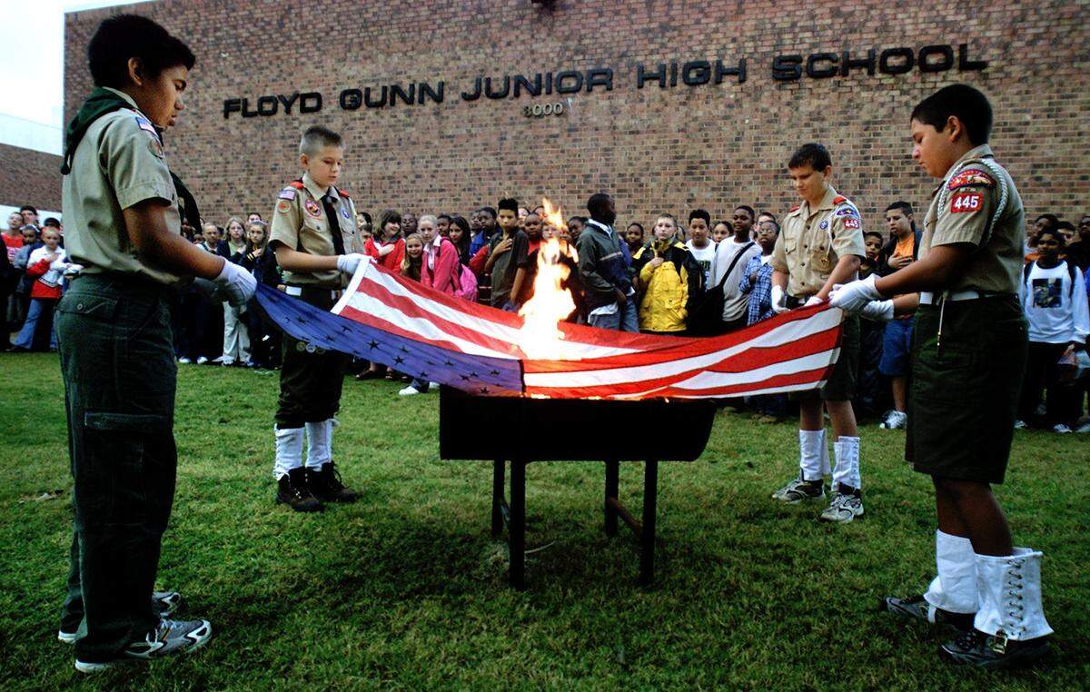 Oct. 11, 2001: A flag retiring ceremony at Gunn Junior High in Arlington, on a somber morning one month after the 9/11 terrorist attacks. Boy Scouts Christian Torres, 11, of Troop 393; Rhys L’Roy, 12, of Troop 445; Tyler Smith, 12, of Troop 445; and Marco Ponti, 12, of Troop 445 hold the flag that had flown over the school for over two years. The ceremony was part of eighth-grade Explorer Scout Tim Jackson’s Eagle Scout project.