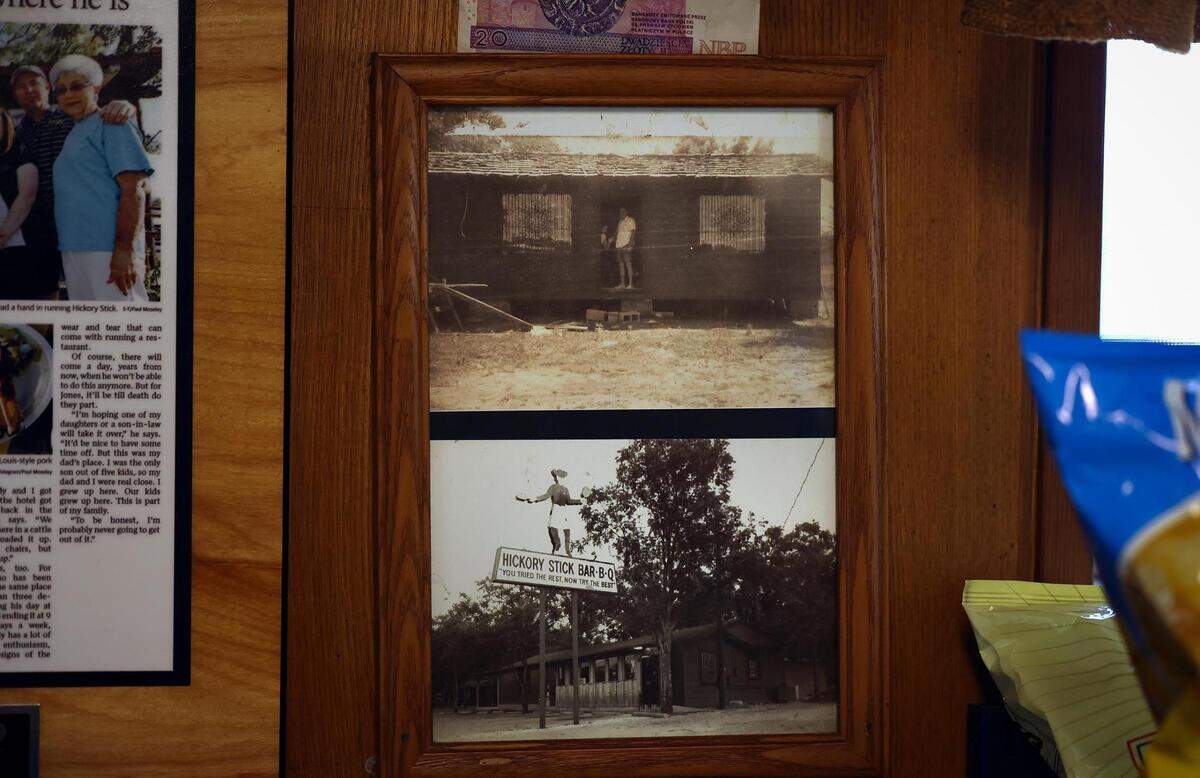 A photograph of Hickory Stick Barbecue before it opened in 1976 is framed on top of a second photo taken in 1979. Mark Jones, the owner, was 14 when his father opened the restaurant.