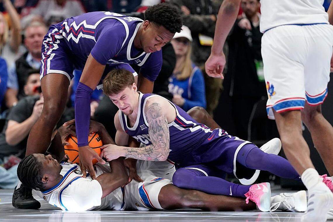 KANSAS CITY, MISSOURI - MARCH 12: Flory Bidunga #40 of the Kansas Jayhawks battles for the ball against Xavier Edmonds #24 of the TCU Horned Frogs and Brock Harding #2 of the TCU Horned Frogs in the first half during the quarterfinals of the Big 12 Tournament at T-Mobile Center on March 12, 2026 in Kansas City, Missouri. (Photo by Ed Zurga/Getty Images)