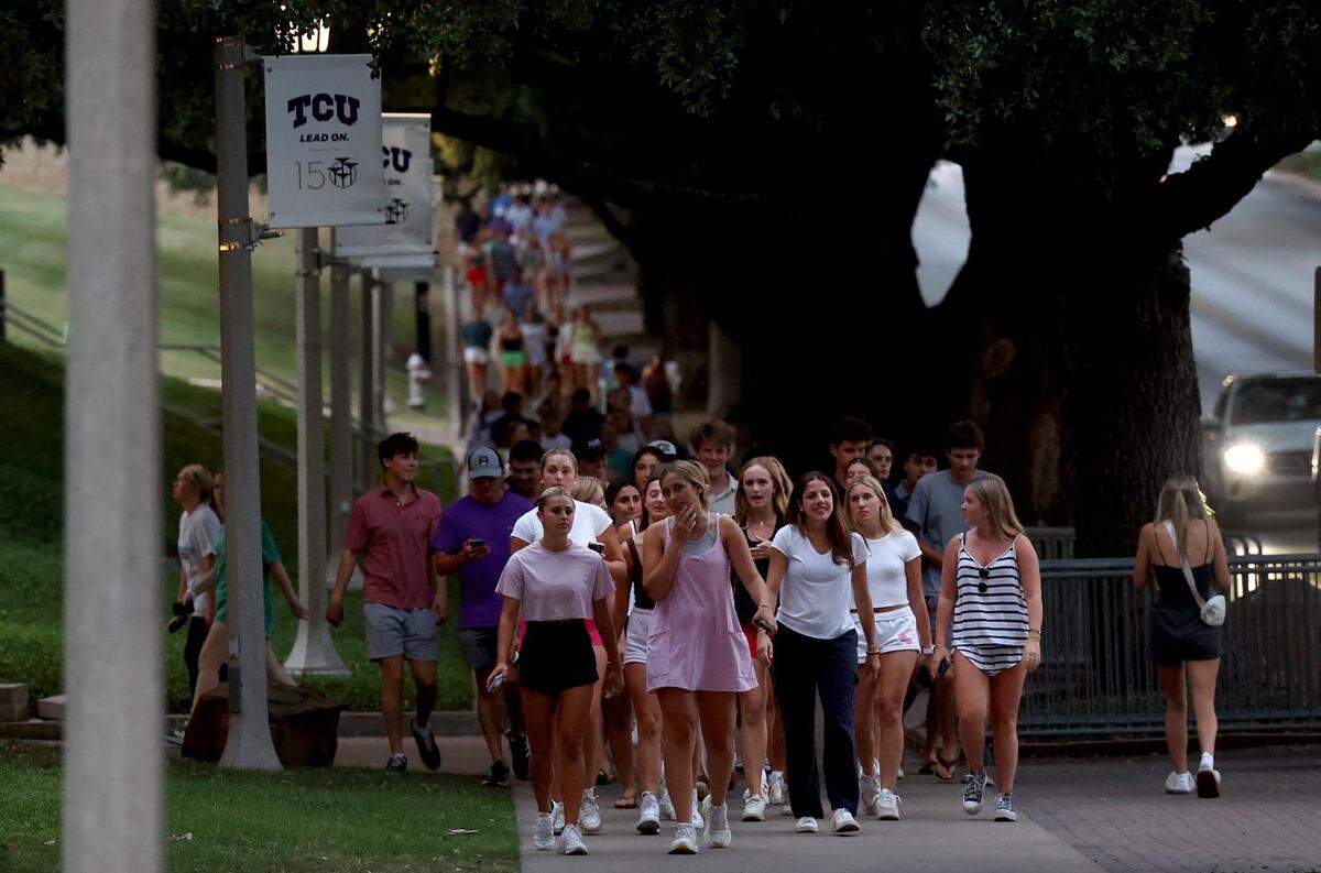 A line of students walking to a vigil for Wes Smith stretches along Stadium Drive on Wednesday, September 6, 2023, in Fort Worth. Smith, a TCU student, was shot and killed in an apparently random act of violence in Fort Worth on Friday.