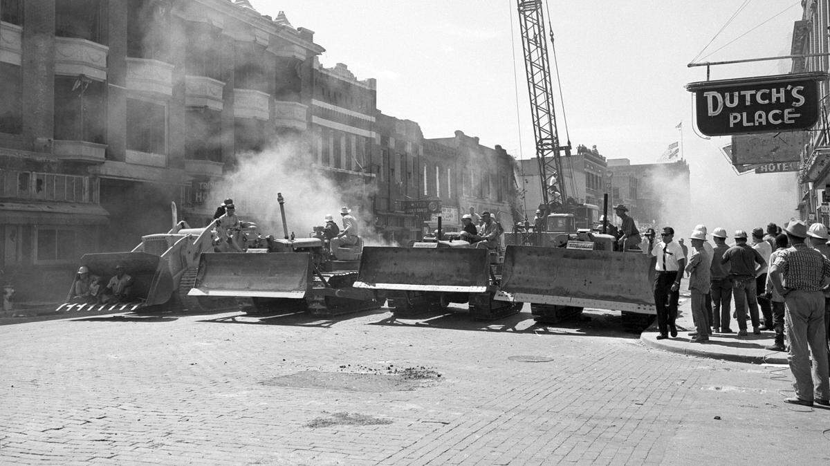 Bulldozers are seen on Main Street in Fort Worth on the first day of demolition to clear buildings for the construction of the Tarrant County Convention Center.