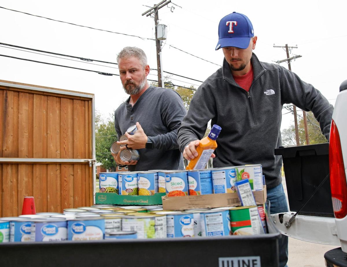 Cousins C.J. Sims and Dylan Sims, from Legacy Baptist Church unload donations collected by the churches Awana Kids Group at Community Link in Saginaw, Texas, Thursday, Nov. 16, 2023. They started serving clients at 9am and completed handing out food by 10:23. They handed out meals for 143 families while turning away more than they served. (Special to the Star-Telegram Bob Booth)