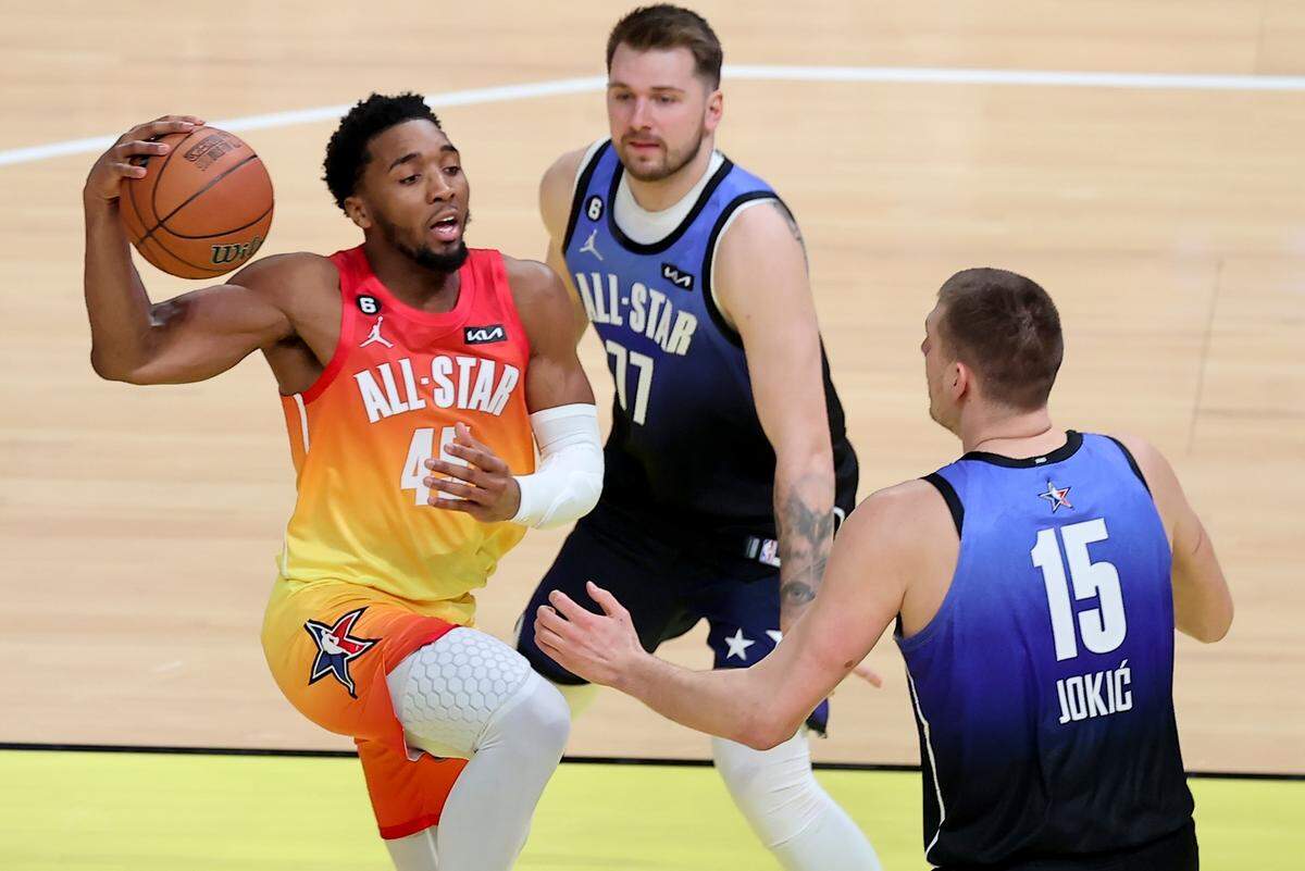 Team Giannis guard Donovan Mitchell (45) drives past Team LeBron forward Luka Doncic (77) and Team LeBron center Nikola Jokic (15) during the first half of the NBA basketball All-Star game Sunday, Feb. 19, 2023, in Salt Lake City.