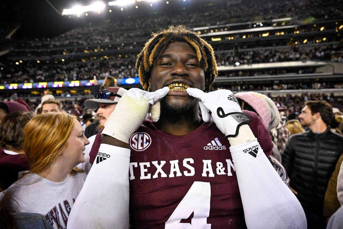 Nov 26, 2022; College Station, Texas, USA; Texas A&M Aggies defensive lineman Shemar Stewart (4) shows off his gold grill smile after the Aggies defeat the LSU Tigers at Kyle Field. Mandatory Credit: Jerome Miron-USA TODAY Sports