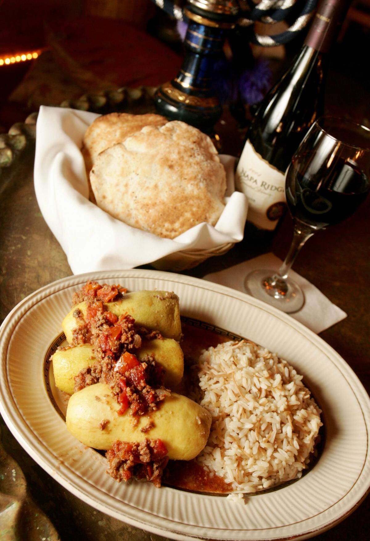 Ablama, baby yellow squash stuffed with ground sirloin, onions and pine nuts topped with fresh diced tomatoes served with vermicelli rice at Byblos Mediterranean.