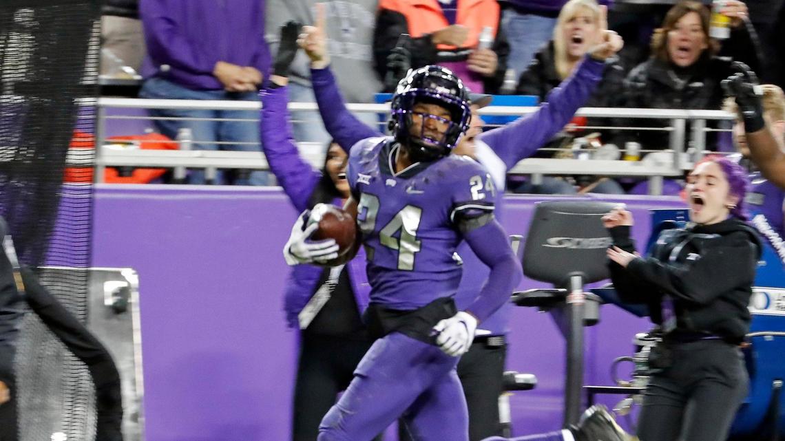 TCU cornerback Josh Newton checks the pursuit as he gets to the end zone with a pick-six in a 2022 game against Iowa State. Newton is one of four Horned Frogs to be named to the All-Big 12 preseason team. 