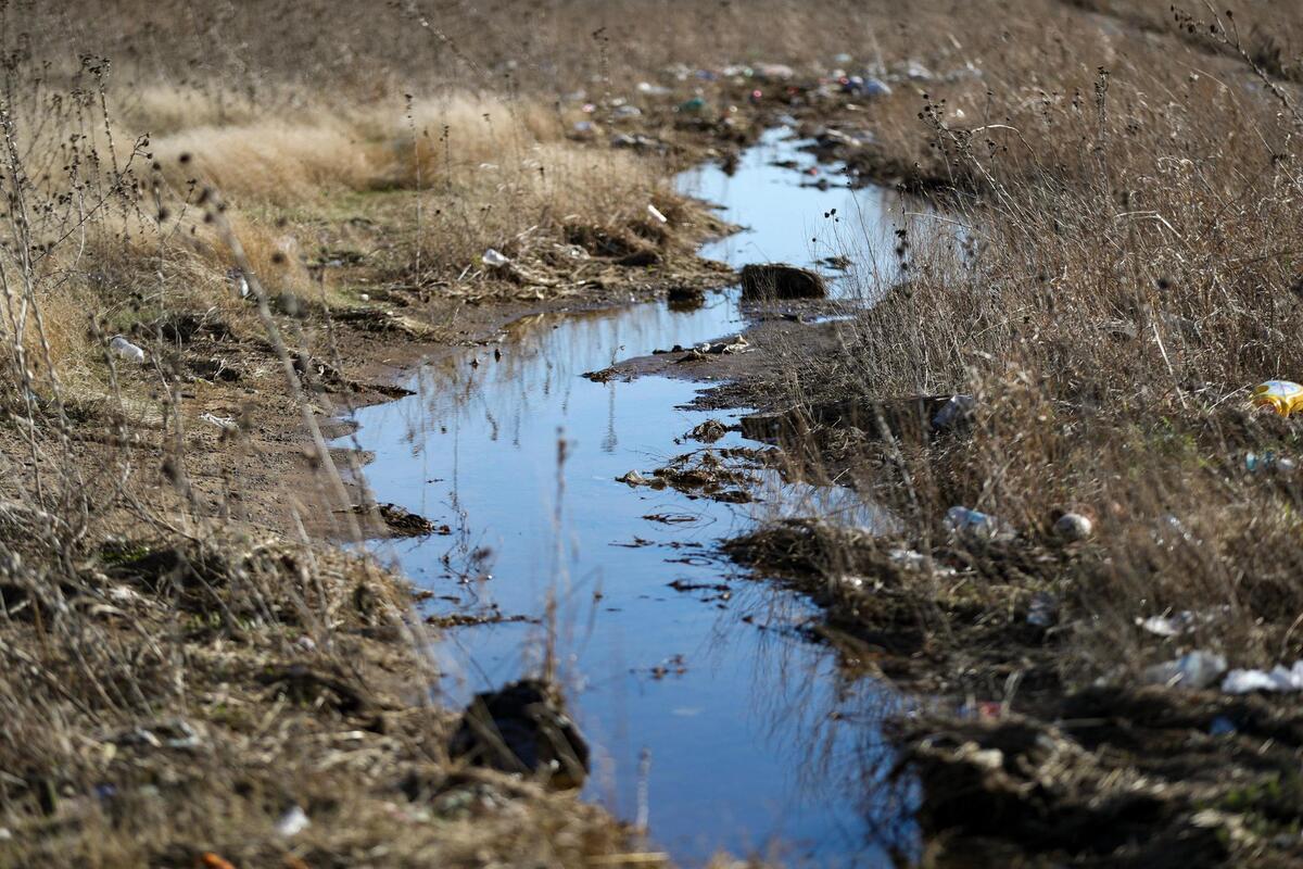 Debris and stagnant water pool outside of the Stallion Pointe Apartments in Everman, Texas, on Saturday, March 4, 2023. Flooding has been a continuous issue in the city just outside of Fort Worth.