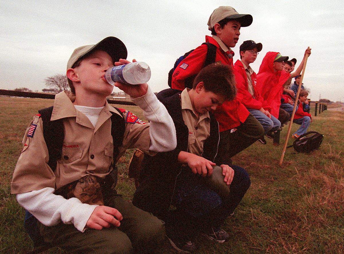 Dec. 15, 2001: Boy Scout Jeff Fruhwirt, left, takes a drink of water while Robert Cayou opens his canteen, as members of Troop 351 take a break on the hike to their new meeting place. Johnathan Olmos, James Trotchie and Josh Ordway sit on a fence behind them. The troop had grown too large for Blue Mound Lion’s Club and will now meet at Lake Worth United Methodist Church.