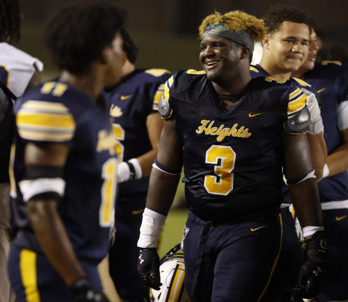 Arlington Heights defensive lineman Caynan James (3) is all smiles as the game comes to an end after the second half of a UIL Conference 5A D1 Bi-District playoff game between Arlington Heights and Brewer at Farrington Field in Fort Worth, Texas, Friday, Nov. 14, 2025.