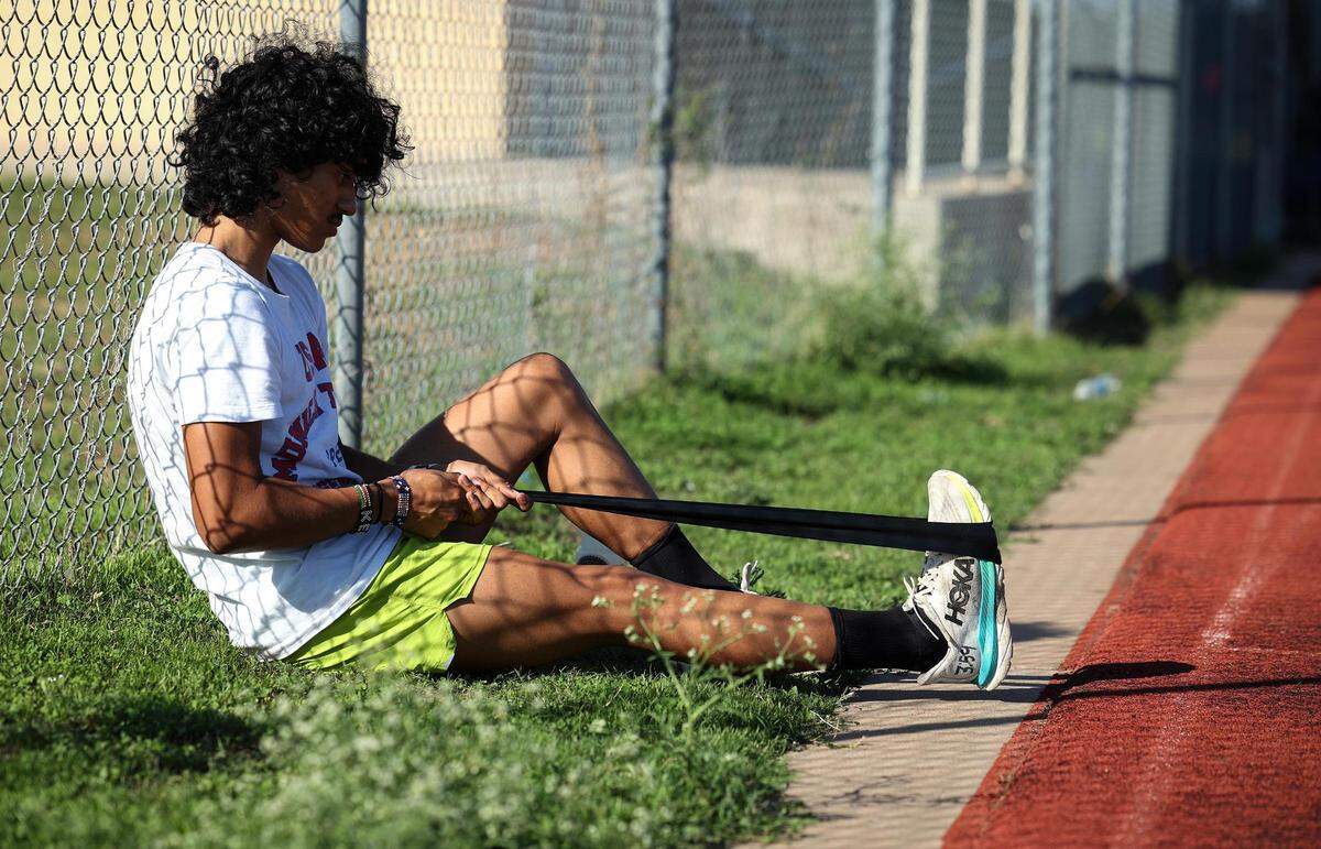 Diamond Hill-Jarvis High School senior Angel Sanchez warms up before a run on Wednesday, November 8, 2023, in Fort Worth. Sanchez has won back to back Class 4A Cross Country State Championships.