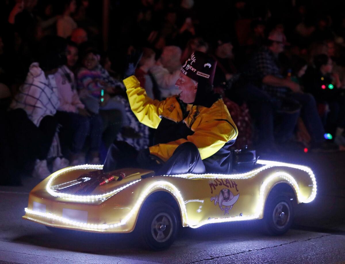 A Shriner driving a Carvette high fives the crowd during the Parade of Lights in downtown Fort Worth, Texas, Saturday, Nov. 24, 2019. More than 100 entries marched in the 2019 Parade of Lights. (Special to the Star-Telegram Bob Booth)
