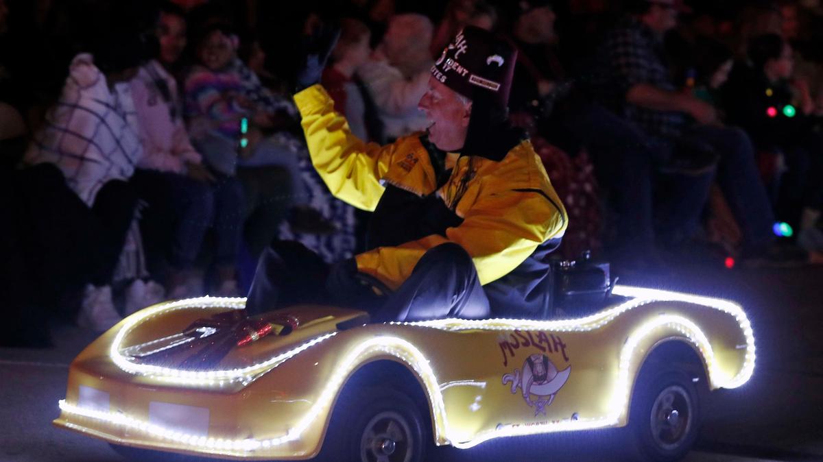 A Shriner driving a Carvette high fives the crowd during the Parade of Lights in downtown Fort Worth, Texas, Saturday, Nov. 24, 2019. More than 100 entries marched in the 2019 Parade of Lights. (Special to the Star-Telegram Bob Booth)