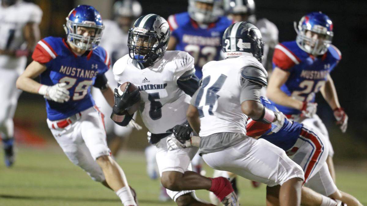Fort Worth YMLA wide receiver Kemoh Turay (6) looks for yardage as Grapevine linebacker Jackson Shadle (29) closes in, Nov. 16, 2017.