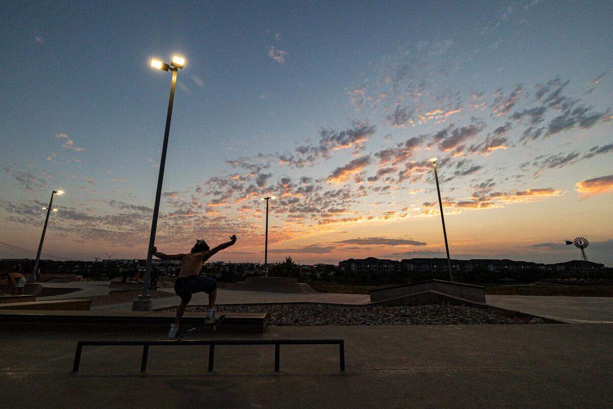 Ramsey Rivera balances on a rail at sunset at Chisholm Trail Skate Park in Fort Worth on Tuesday, Aug. 29, 2023.