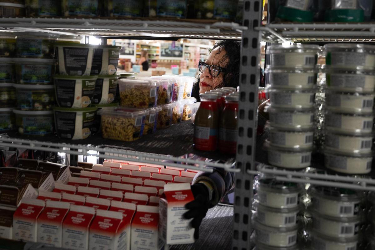 Town Talk Foods employee Josefina Jimenez stocks the dairy section at on Monday, April 22, 2025.