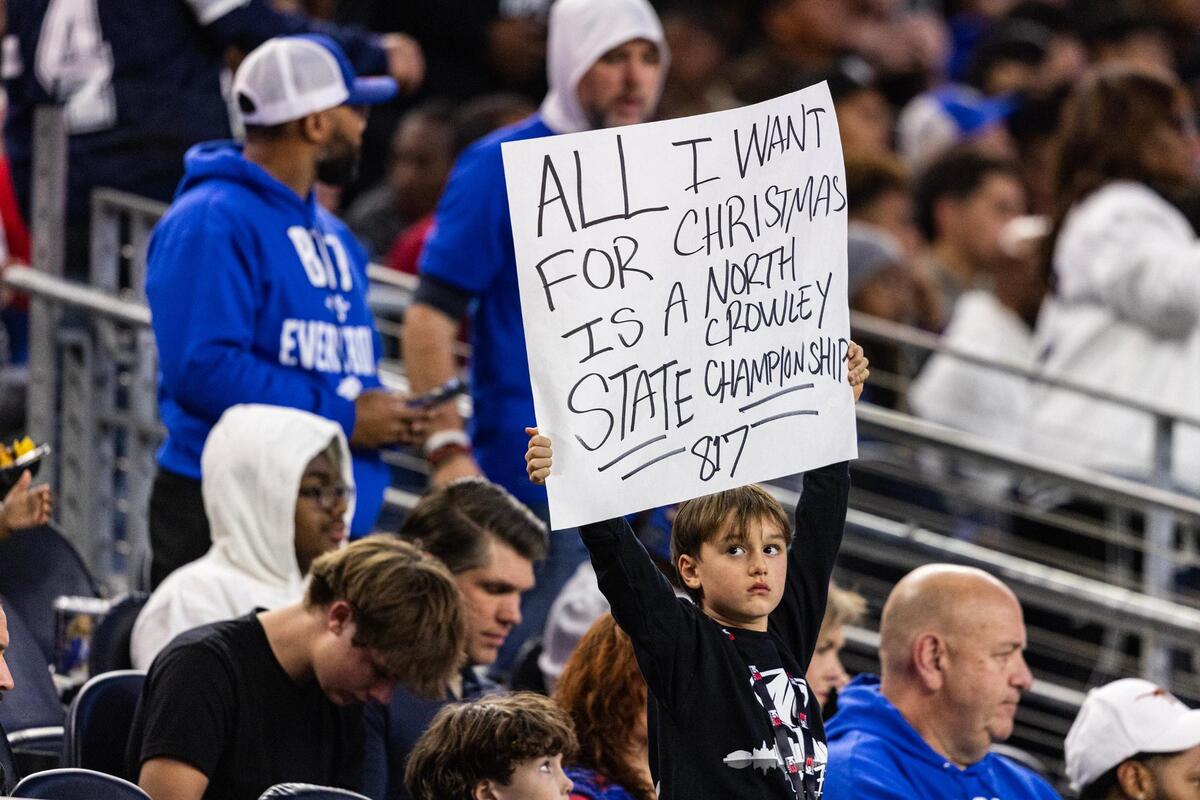 A young fan holds a sign in support of the North Crowley Panthers football team prior to the UIL 6A Division I championship game at AT&T Stadium in Arlington on Saturday, Dec. 21, 2024.