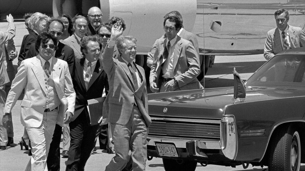 President Jimmy Carter waves on the tarmac to hundreds of people greeting him at Carswell Air Force Base in Fort Worth on June 23, 1978.