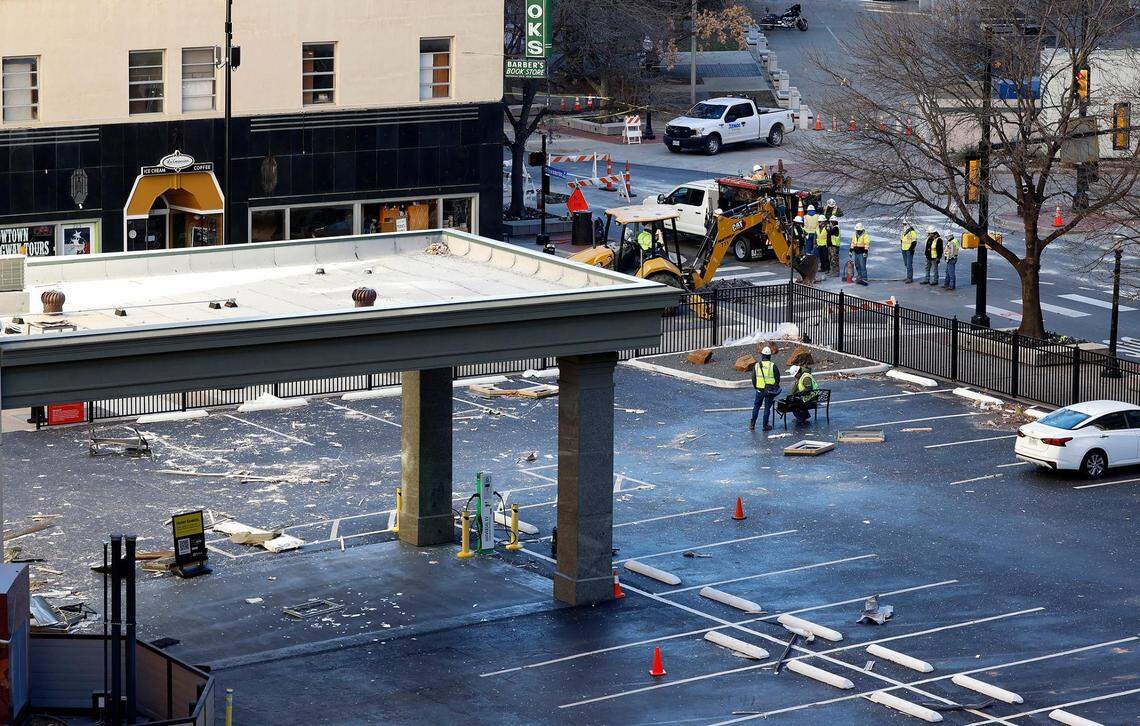 Atmos Energy crews work near the Sandman Signature Hotel at the intersection of Throckmorton and East 8th Streets on Tuesday, January 9, 2024, in downtown Fort Worth.