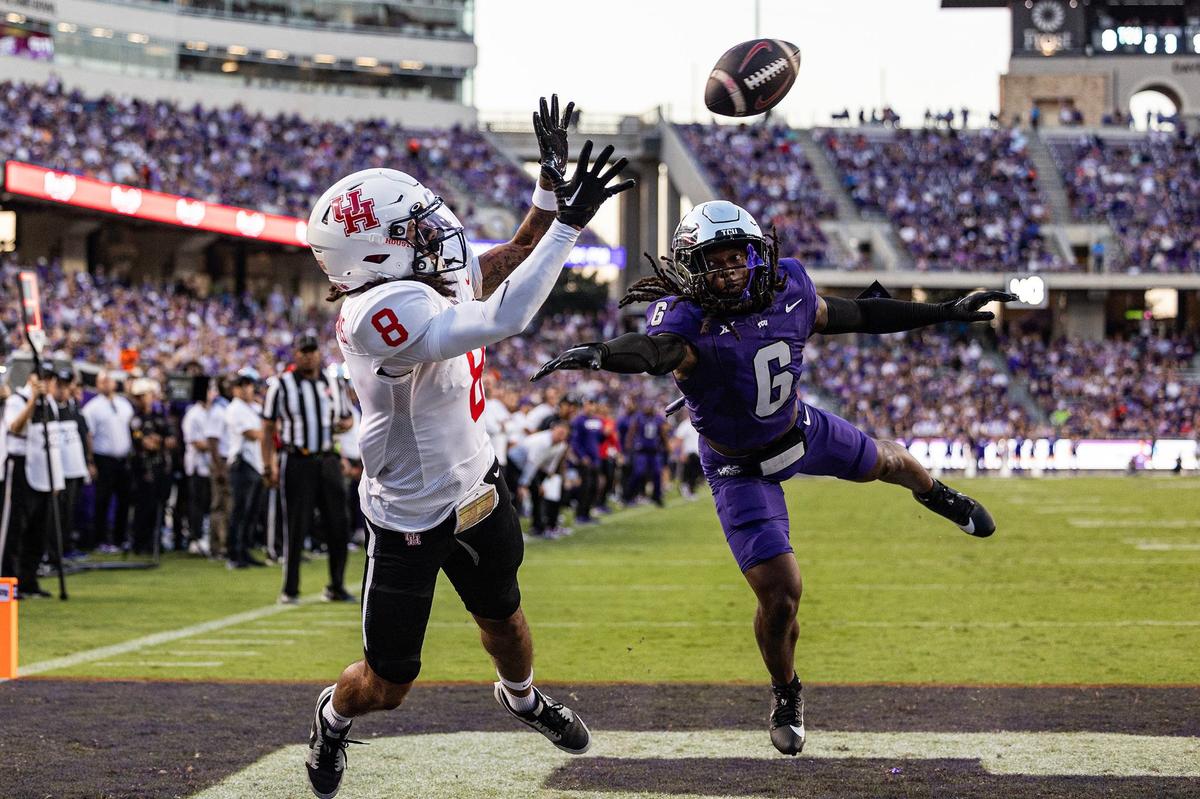 Houston wide receiver Devan Williams (8) catches a touchdown pass against TCU cornerback LaMareon James (6) in the first half of an NCAA football game at Amon G. Carter Stadium in Fort Worth on Friday, Oct. 4, 2024.