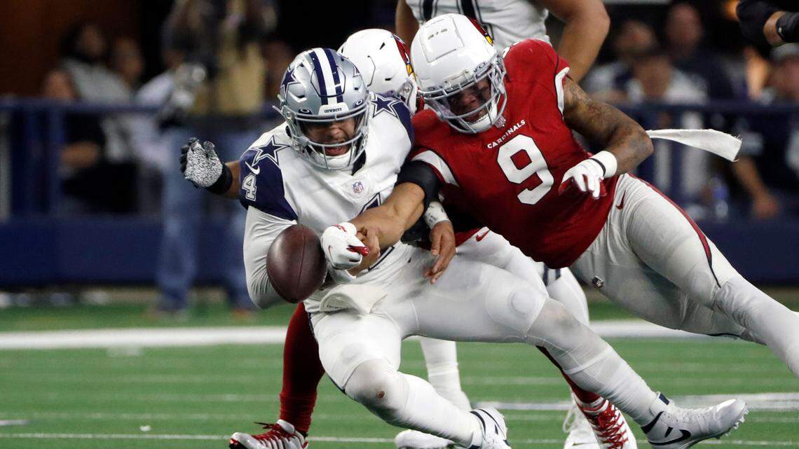 Arizona Cardinals inside linebacker Isaiah Simmons (9) forces a fumble by Dallas Cowboys quarterback Dak Prescott (4) during the second half of Sunday’s game in Arlington.