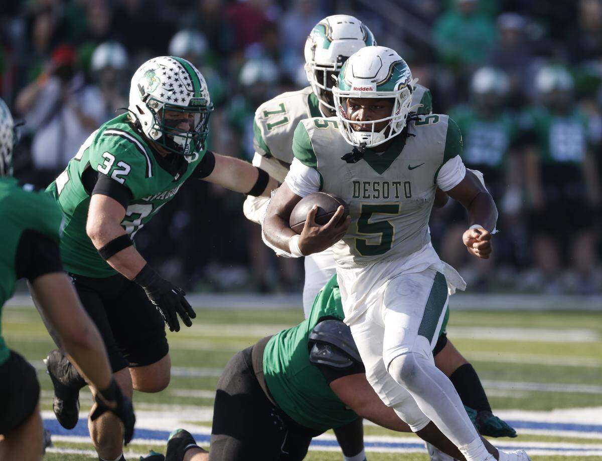 DeSoto running back SaRod Baker finds a hole in the middle of the Southlake Carroll line during the first half of a Class 6A Division II state semifinal Saturday at Newsom Stadium in Mansfield.