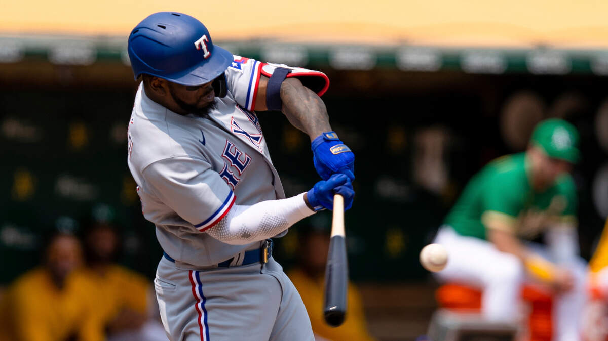 Texas Rangers’ Adolis Garcia hits a two-run home run against the Oakland Athletics during the first inning of a baseball game in Oakland, Calif., Saturday, Aug. 7, 2021. (AP Photo/John Hefti)