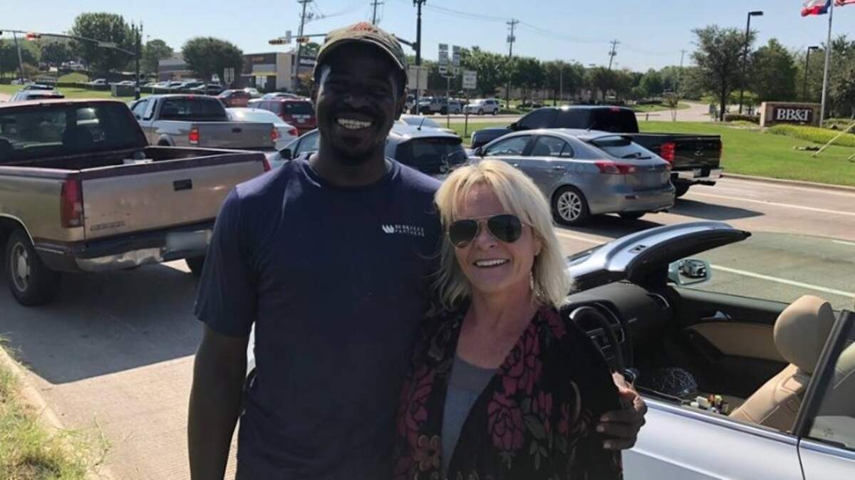 Joshua Stewart of Dallas (l) gives a hug Saturday morning to Martha Stewart of Grapevine after she helped him when his truck broke down on Texas 114 in Southlake.