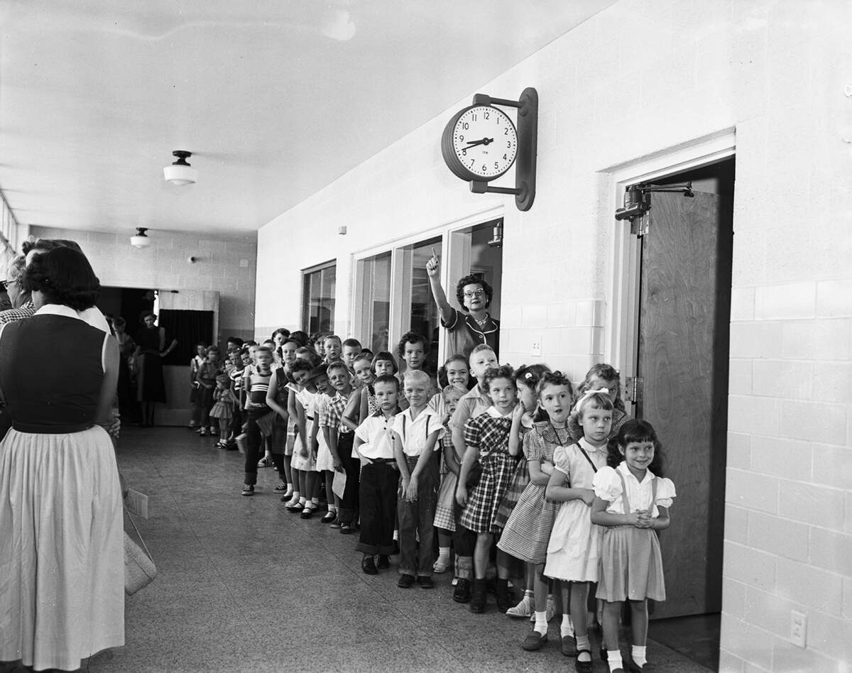 Sept. 7, 1954: Pupils at Glencrest Elementary School were all ready to go to their classrooms before the 9 a.m. starting time Tuesday, opening day for Fort Worth school children. Miss Loraine McMillon, principal of the new school, is pointing to the clock.
