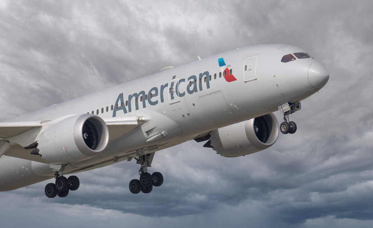 An American Airlines plane soars in the sky.
