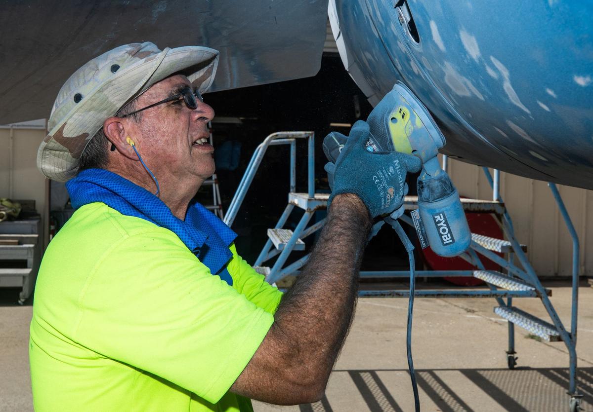 Retired Air force veteran Keven Nelson sands the paint off a sun damaged plane on Thursday, August 1, 2024 at the Fort Worth Aviation Museum. Nelson retired from the Air Force in 1979 after saying “no more” to the military constantly moving him from place to place. He now been restoring planes for the past 10 years at the museum. “I just needed something to do” Nelson said “I’d been up here a couple of times just to visit. They’re always looking for somebody to come out to help. I just get into it.”