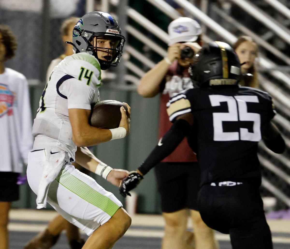 Haslet Eaton quarterback Noah Lugo (14) skirts the sidelines defended by Keller Fossil Ridge defensive back Cameron Smith (25) in the first half of a UIL high school football game at Keller ISD Stadium in Keller, Texas, Thursday, Sept. 21, 2023. Eaton led 24-14 at the half.