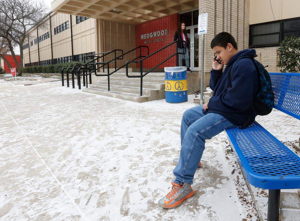 Feb. 6, 2014: Seventh-grader Adrian Paredes waits for his ride as Wedgwood Middle School students were dismissed early due to snow.
