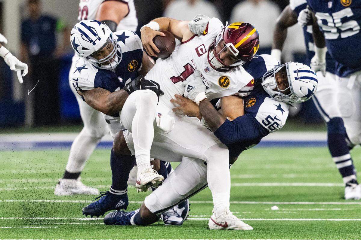 Dallas Cowboys linebacker Micah Parsons (11) and defensive end Dante Fowler (56) sack Washington Commanders quarterback Sam Howell (1) during the second quarter of the Thanksgiving NFL game between the Dallas Cowboys and the Washington Commanders at AT&T Stadium in Arlington on Thursday, Nov. 23, 2023.