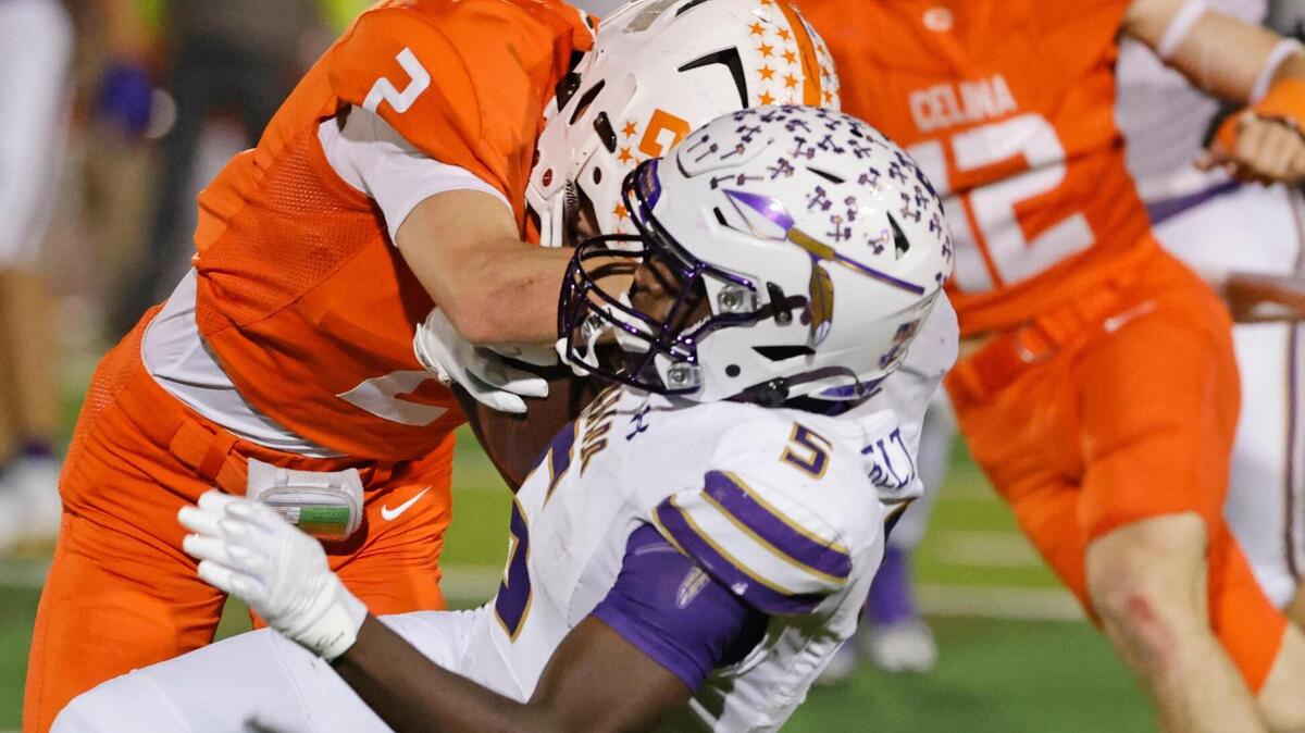 Celina defensive back Colton Rodriguez (2) knocks Alvarado running back Demarcus Belton (5) sideways during the UIL 4A D1 quarterfinals at Mustang-Panther Stadium in Grapevine on Friday.